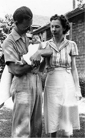Picture of Sandra Lee Willis held by father L. Roy Willis, Jr. with mother looking on, Easton, Maryland August 1941