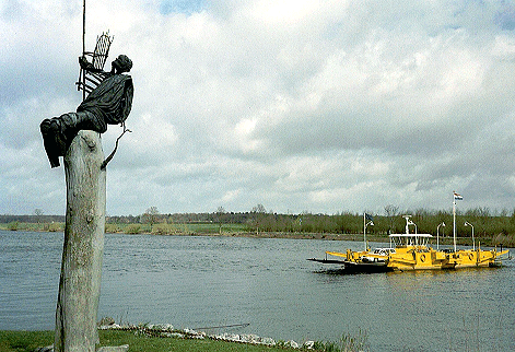 Wide shot of the Sculpture of Christoffel by Knippenberg at Broekhuizen that includes the river Maas and ferry, Limburg, Netherlands